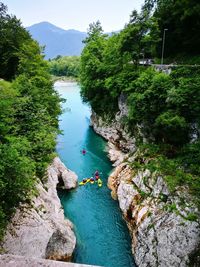 High angle view of river amidst trees against sky