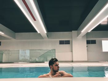 Portrait of shirtless man in swimming pool