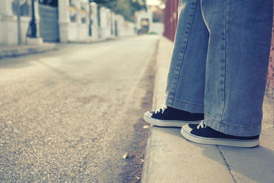 Low section of women standing on street