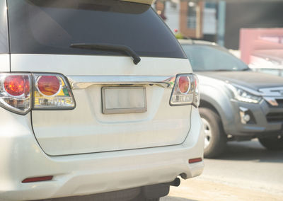 Close-up of car on road