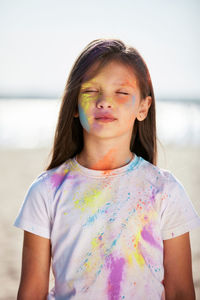 Portrait of young woman standing against sky