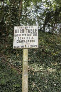 Information sign board on tree in forest