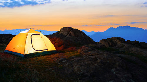 Tent against sky during sunset