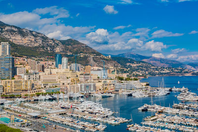 High angle view of townscape by sea against sky