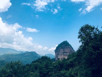 View of maijishan grottoes against cloudy sky