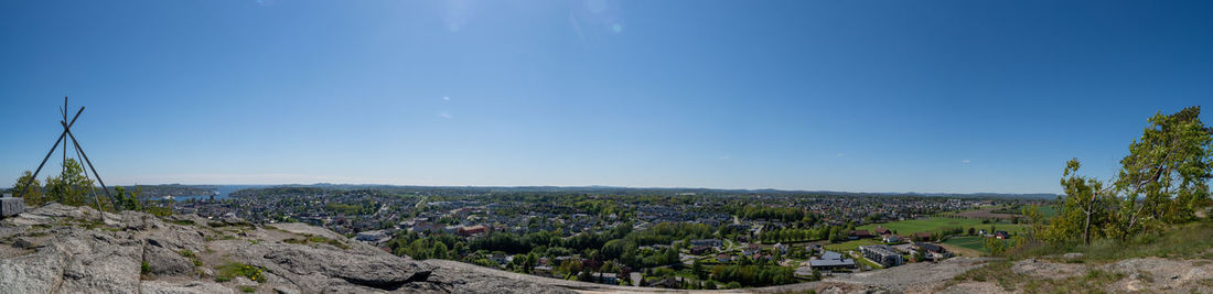 Panoramic view of landscape against blue sky