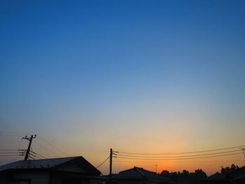 Low angle view of silhouette buildings against clear sky during sunset