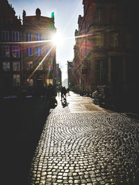 People on street amidst buildings in city