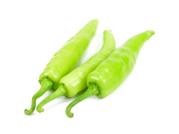 Close-up of green chili pepper against white background