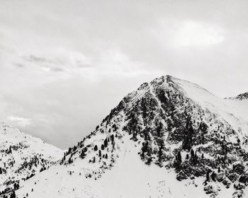 Low angle view of snow covered mountain against sky