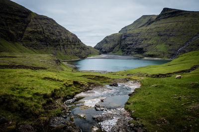 Scenic view of lake and mountains against sky