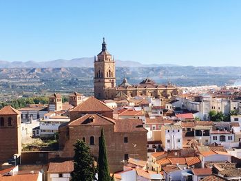 Buildings in town against clear sky