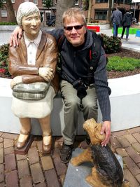 Portrait of friends with arms raised outdoors
