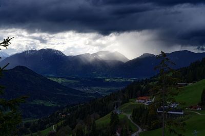 Scenic view of mountains against cloudy sky