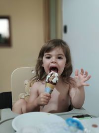 Portrait of happy girl sitting at home