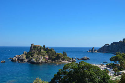 Scenic view of sea against clear blue sky