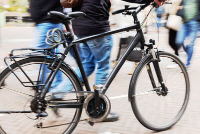 Low section of people riding bicycle on street