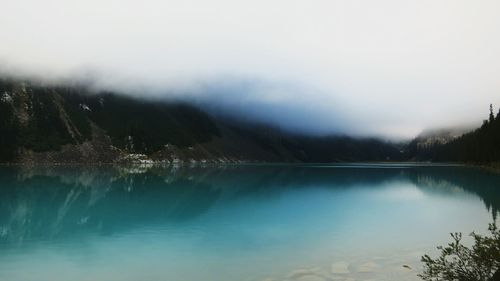Scenic view of lake with mountains in background