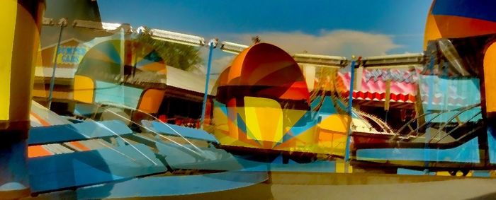 Low angle view of multi colored wall against blue sky