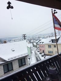 Cars on snow covered sea against sky