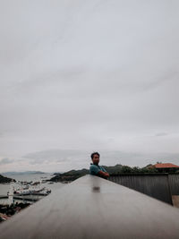 Rear view of woman walking on road against sky