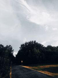 Road amidst trees against sky