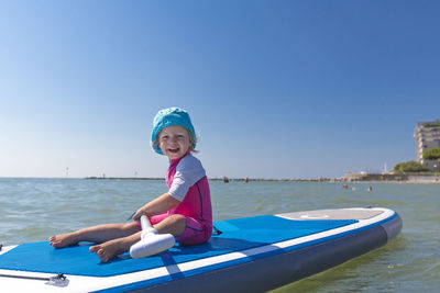 Rear view of woman standing on boat