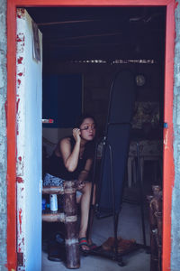 Portrait of woman sitting at home