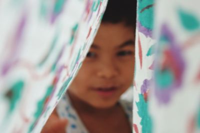 Close-up of boy seen through fabric