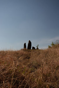 Standing sacred stone monoliths with bright blue sky and grass from a different perspective