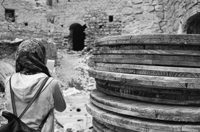 Rear view of man on old wall