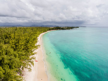 Scenic view of beach against cloudy sky