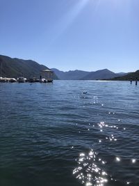 Scenic view of iseo lake against clear blue sky