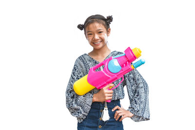 Portrait of smiling young woman against white background