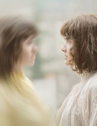 Double exposure of woman standing outdoors