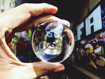 Close-up of hand holding crystal ball