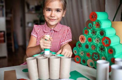 Portrait of cute girl sitting on table