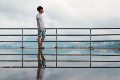 Rear view of woman standing against sky