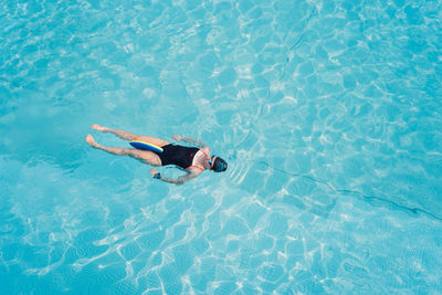 High angle view of woman swimming in pool