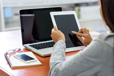 Midsection of woman using mobile phone