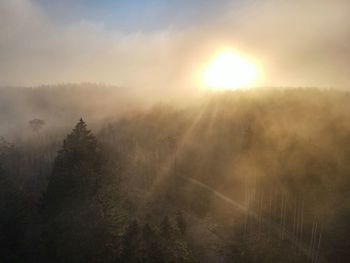 Scenic view of landscape against sky during foggy weather