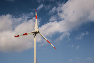 Low angle view of industrial windmill