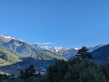 Scenic view of mountains against clear blue sky