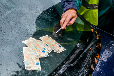 High angle view of man holding wet glass