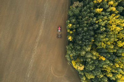 High angle view of road amidst trees on field