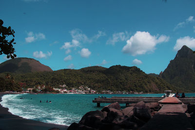 Scenic view of sea and mountains against sky