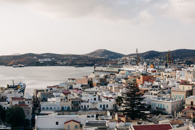 High angle view of townscape by sea against sky