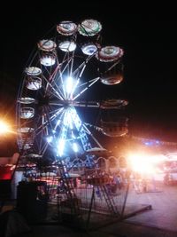 Low angle view of illuminated lights at night