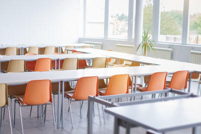 Empty chairs and tables in cafe