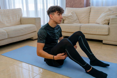 Full length of man exercising at home